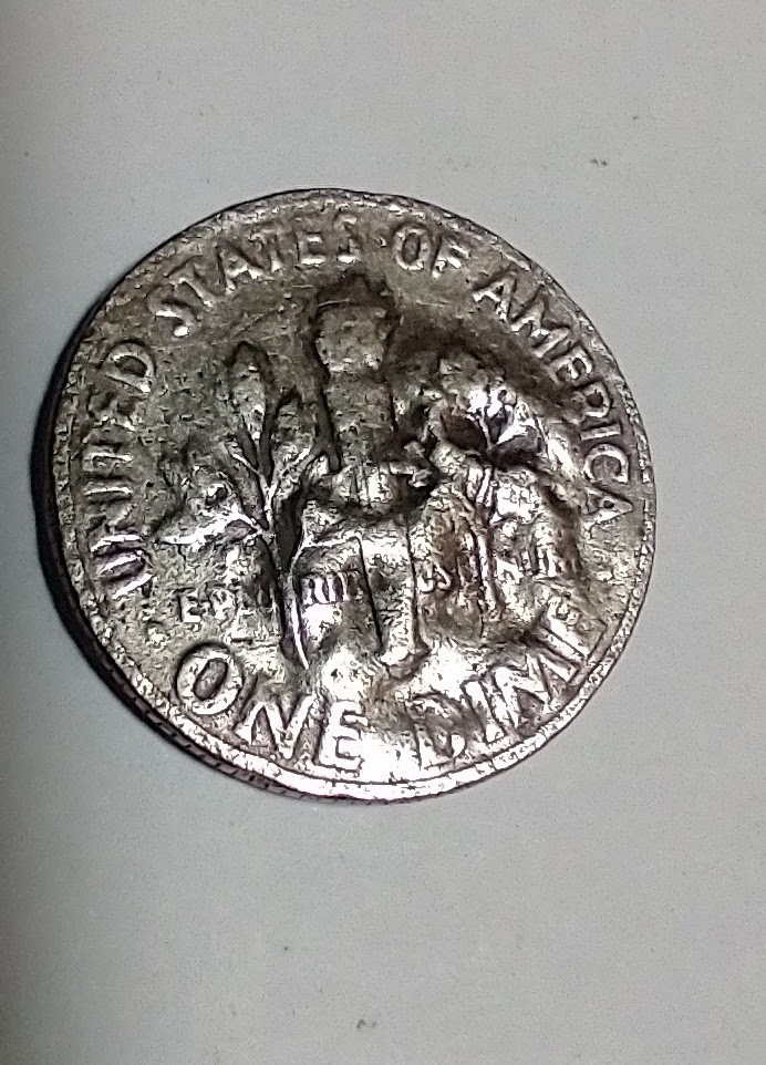 Looking-For-Thoughts-On-The-Curious-Surface-On-This-1966-Roosevelt-Dime